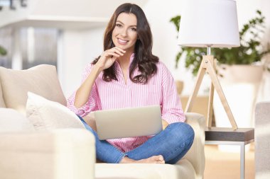 Evde bilgisayarını kullanan bir kadın.