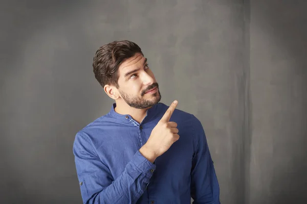 young man pointing up