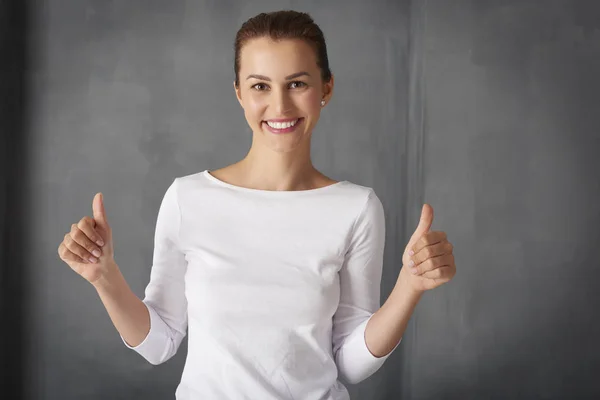 young woman giving thumbs up