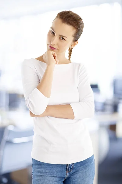 businesswoman with hand on chin at office