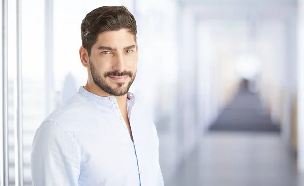 young man standing indoor.