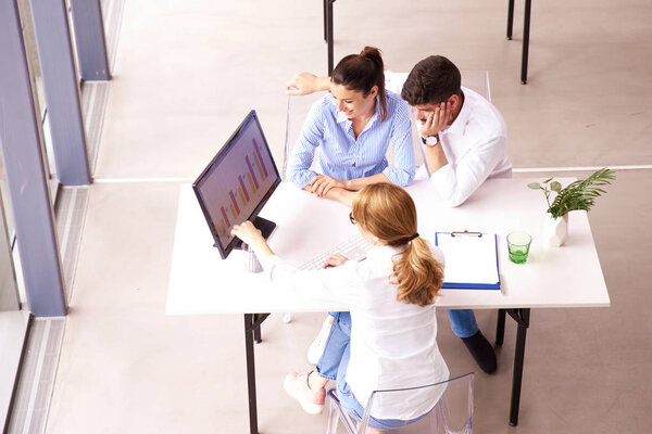 Investment advisor businesswoman consulting with young couple in