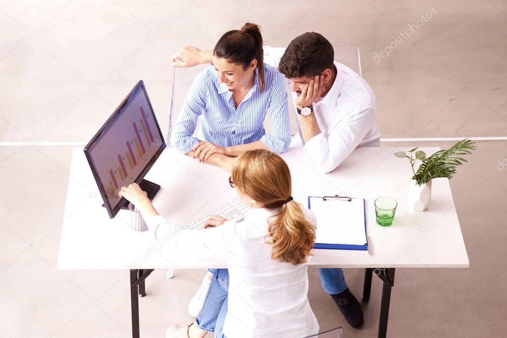 Investment advisor businesswoman consulting with young couple in