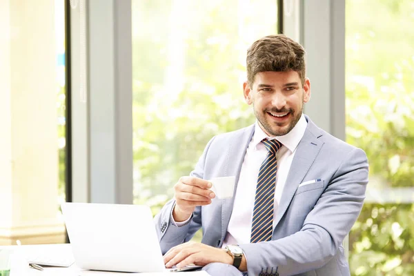 Portrait of professional businessman wearing suit and drinking c — Stock Photo, Image