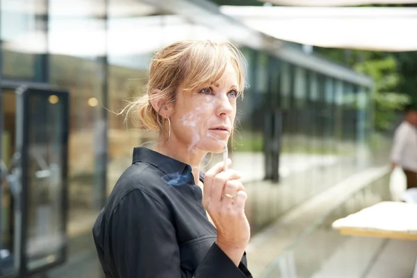 Middle aged woman smoking cigarette