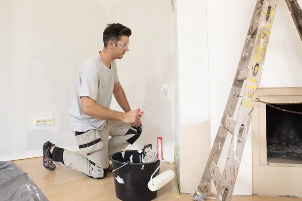 Joven pintor pintando superficies — Foto de Stock