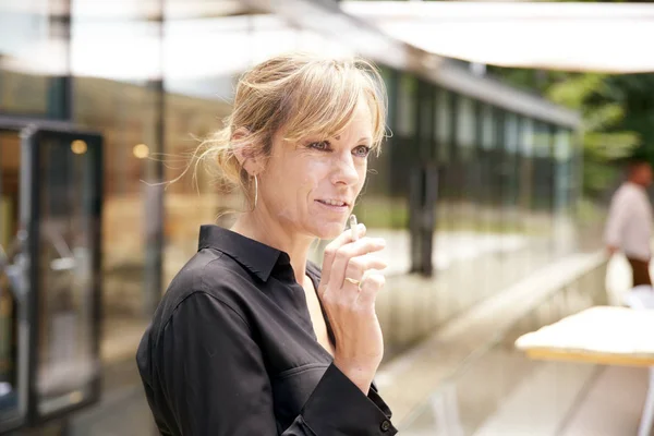 Middle aged woman smoking cigarette