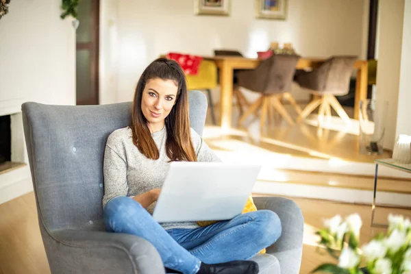 Mulher de negócios casual usando laptop enquanto trabalhava online a partir de casa — Fotografia de Stock