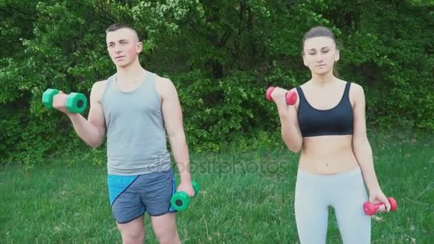 Couple practicing with a dumbbell — Stock Video