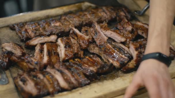 Garçom corta costelas de porco fritas — Vídeo de Stock