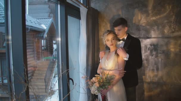 jeune couple se tient près de la fenêtre 