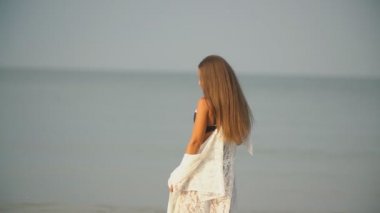 girl walks by the sea near the shore
