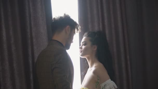 Пара стоїть біля вікна — стокове відео