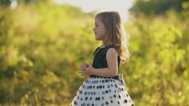 Little girl straightens hair with hand — Stock Video