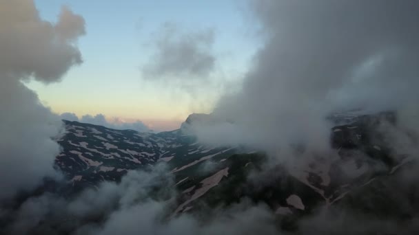 Légi felvétel: Repül a felhők fölött a hegyekben — Stock videók