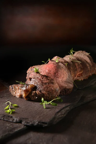 Sliced Rare Roast Beef Joint Shot Dark Rustic Background Thyme — Stock Photo, Image
