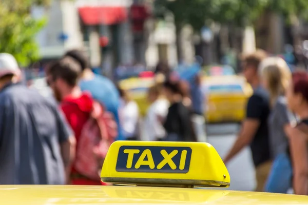 Yellow taxi sign on cab vehicle roof — Stock Photo, Image