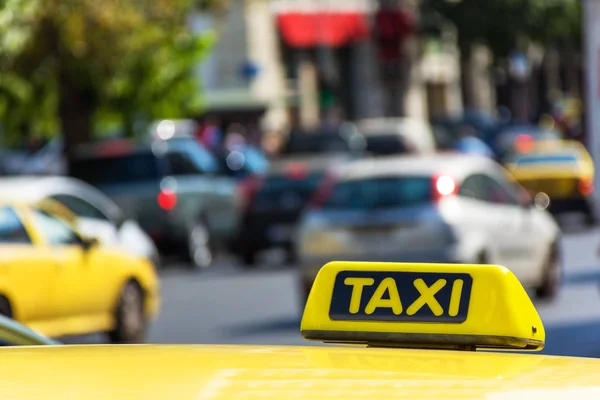 Yellow taxi sign on cab vehicle roof — Stock Photo, Image