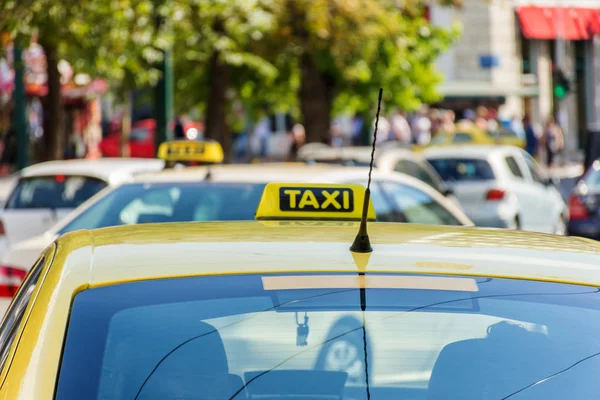 Yellow taxi sign on cab vehicle roof Royalty Free Stock Photos