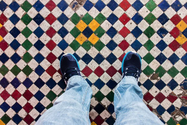 feet on colorful floor