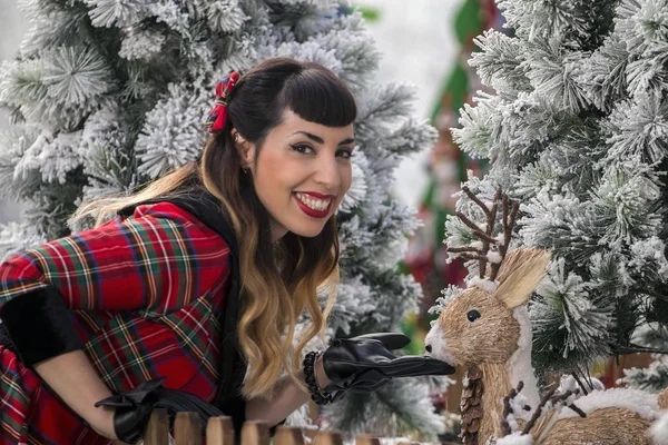 Christmas pinup girl with deer — Stock Photo, Image