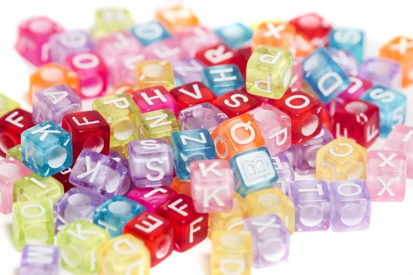 Colorful plastic beads with letters — Stock Photo, Image