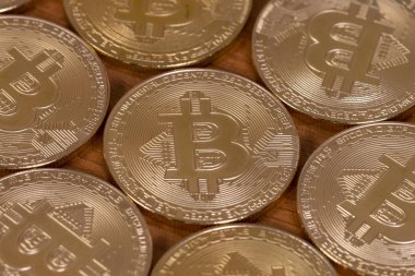 ahşap masa üstünde birkaç altın bitcoins.