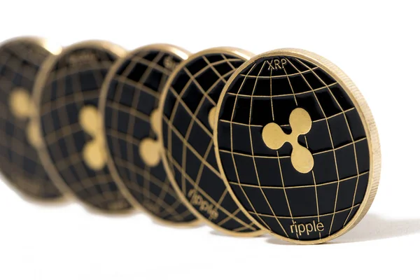 Shiny golden and black ripple coins over a white background.