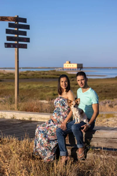 Pregnant happy couple with small dog — ストック写真