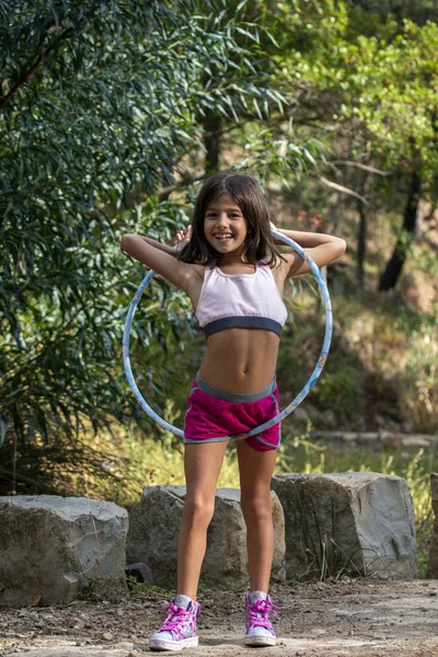 Cute girl posing with hula hoop — Stock Photo, Image