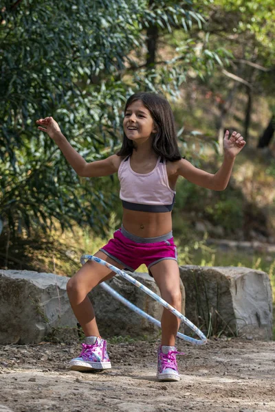 Cute girl posing with hula hoop — Stock Photo, Image