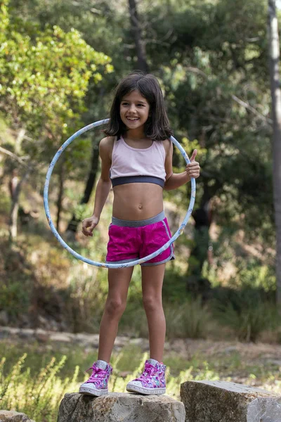 Cute girl posing with hula hoop — Stock Photo, Image