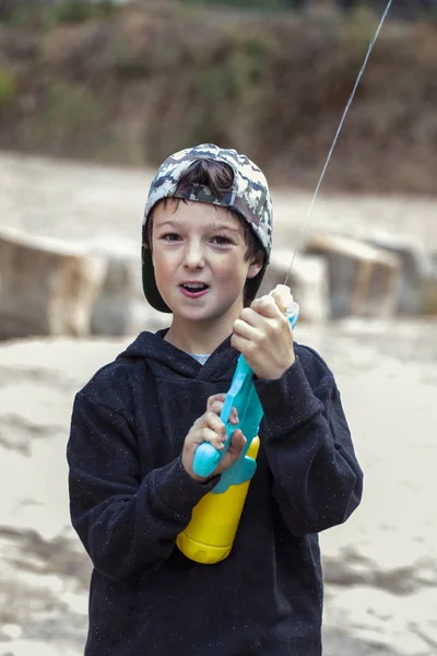 Cute boy with water gun — Stock Photo, Image