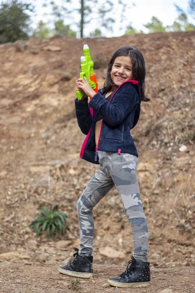 Cute girl with water gun — Stock Photo, Image