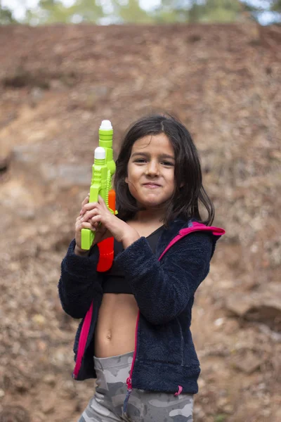 Cute girl with water gun — Stock Photo, Image