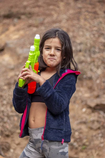 Cute girl with water gun — Stock Photo, Image