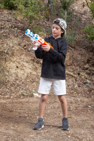 Cute boy with water gun — Stock Photo, Image