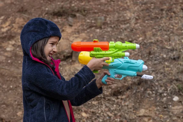 Cute girl with water gun — Stock Photo, Image