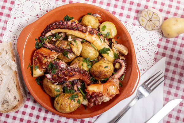 Grilled ocotpus with potatoes, garlic and salsa.