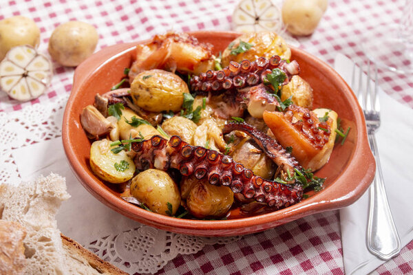 Grilled ocotpus with potatoes, garlic and salsa.