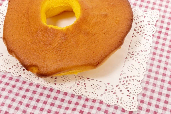 Pao de Lo de Ovar, typical cake of Portugal, on a red table cloth.