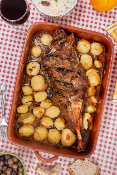Typical portuguese meal of homemade roast lamb with potatoes .