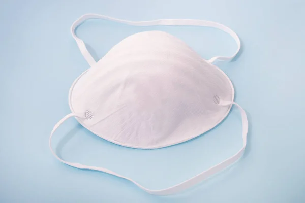 face mask or dust mask  isolated on a light blue background.