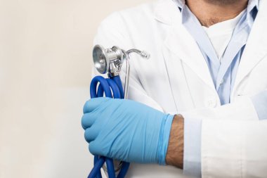 Beyaz arka planda beyaz önlüklü, steteskop ve laboratuvar beyaz önlüklü beyaz doktor..