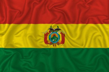 Dalgalı ipek kumaş arka planında Bolivya ülke bayrağı.