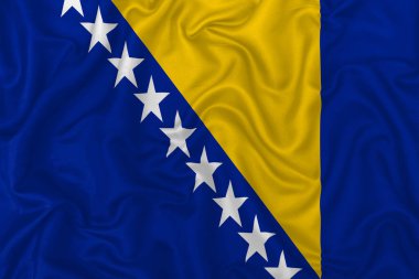 Bosna-Hersek ülke bayrağı dalgalı ipek kumaş arka planında.