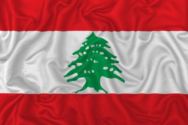 Dalgalı ipek kumaş arka planında Lübnan ülke bayrağı.