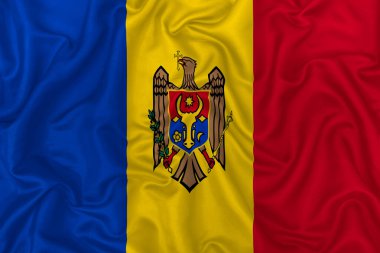 Dalgalı ipek kumaş arka planında Moldova ülke bayrağı.