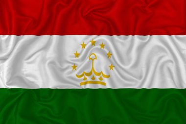 Dalgalı ipek kumaş arka planında Tacikistan ülke bayrağı.