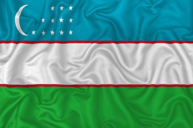Dalgalı ipek kumaş arka planında Özbekistan ülke bayrağı.